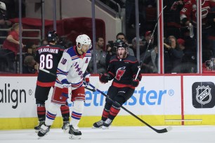 Artemi Panarin skates away while Stefan Noesen (23) celebrates with Teuvo Teravainen (86) after scoring a goal during the Rangers' 4-3 Game 4 loss to the Hurricanes.