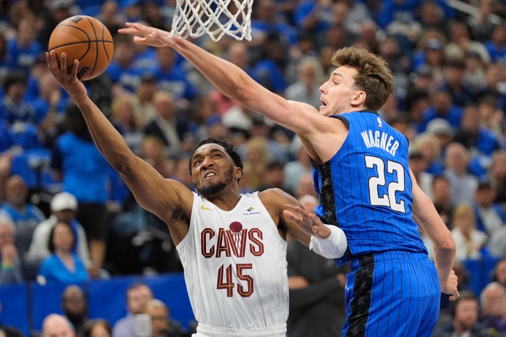Cleveland Cavaliers guard Donovan Mitchell (45) takes a shot around Orlando Magic forward Franz Wagner (22) during the first half of Game 6 of an NBA basketball first-round playoff series, Friday, May 3, 2024, in Orlando, Fla. 