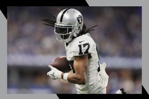 Raiders wide receiver Davante Adams runs with the football.