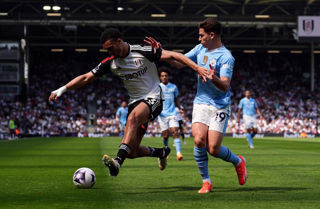 Fulham's Antonee Robinson and Manchester City's Julian Alvarez (right) battle for the ball during the Premier League match at Craven Cottage, London. Picture date: Saturday May 11, 2024. 