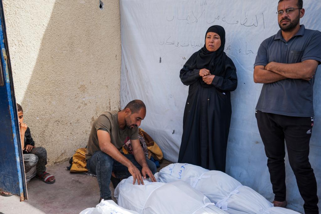 Palestinians mourn their relatives who were killed in an Israeli airstrike in Nuseirat, at the Al Aqsa hospital in Deir al Balah, Gaza Strip