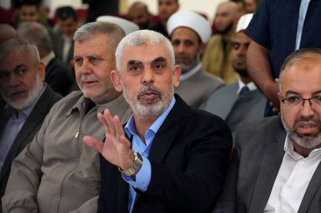 Yahya Sinwar, head of Hamas in Gaza, greets his supporters upon his arrival at a meeting in a hall on the sea side of Gaza City.