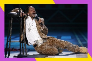 Katt Williams cracks jokes from the floor, leaning against a stool.