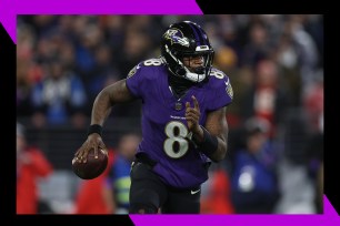 Baltimore Ravens quarterback Lamar Jackson runs with the ball.