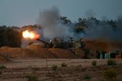 An Israeli self-propelled howitzer fires a shell to the Gaza Strip near the Kerem Shalom crossing in southern Israel, on May 8, 2024.