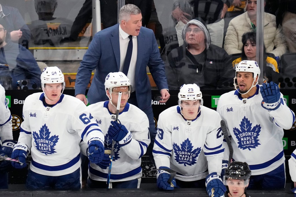 Toronto Maple Leafs head coach Sheldon Keefe, top center, calls to his players during the third period of Game 2 of an NHL hockey Stanley Cup first-round playoff series against the Boston Bruins, Monday, April 22, 2024, in Boston. 