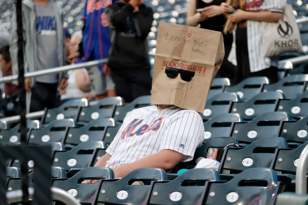 A New York Mets fan covers his face with a paper bag