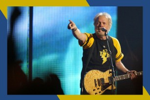 Bachman-Turner Overdrive frontman Randy Bachman points to the crowd with his guitar in hand.