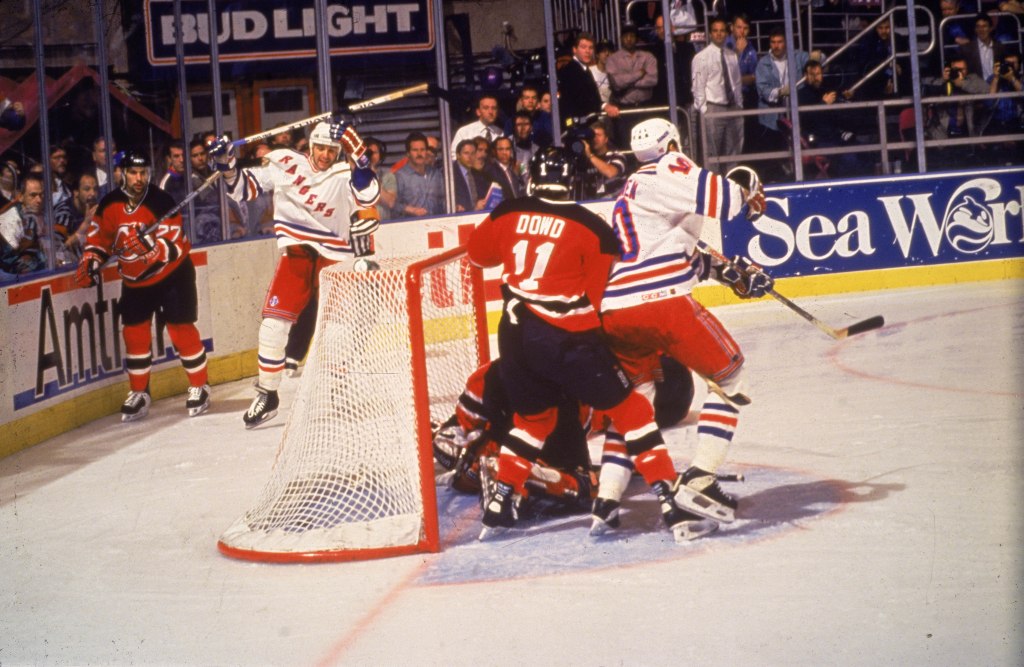 Stephane Matteau (back of net with stick raised) celebrates after scoring the game-winning goal for the Rangers in Game 7 of their Eastern Conference final win over the Devils in 1994.