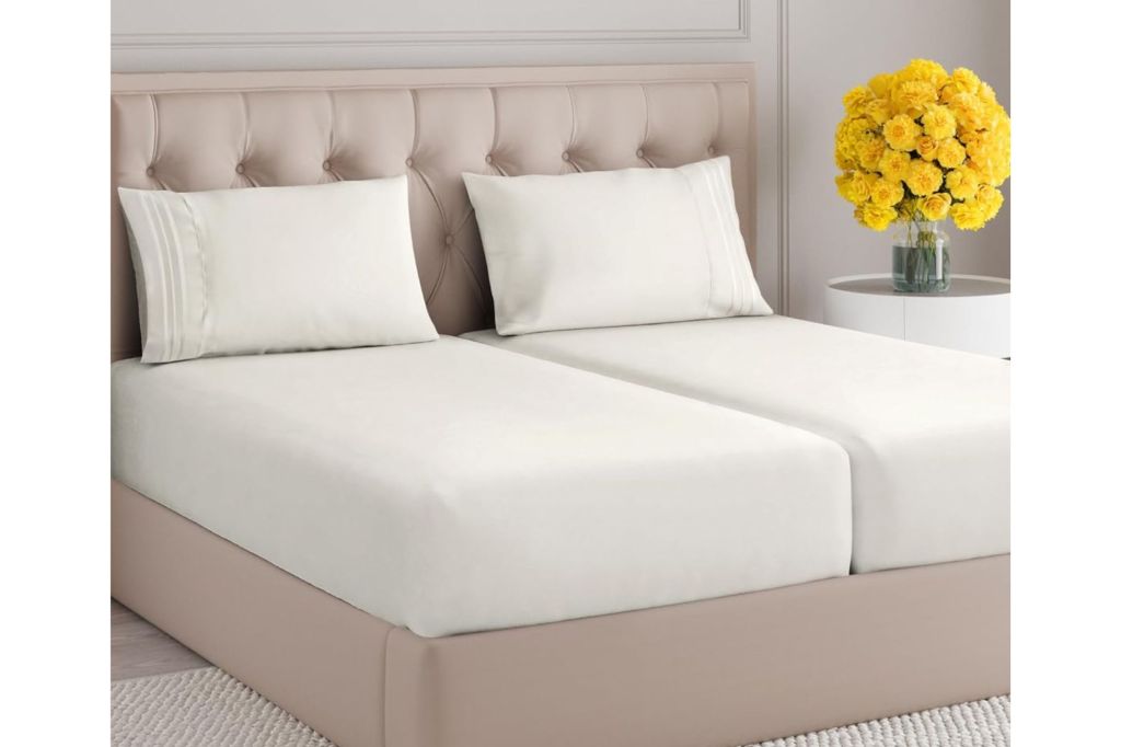 A split king bed with white sheets.