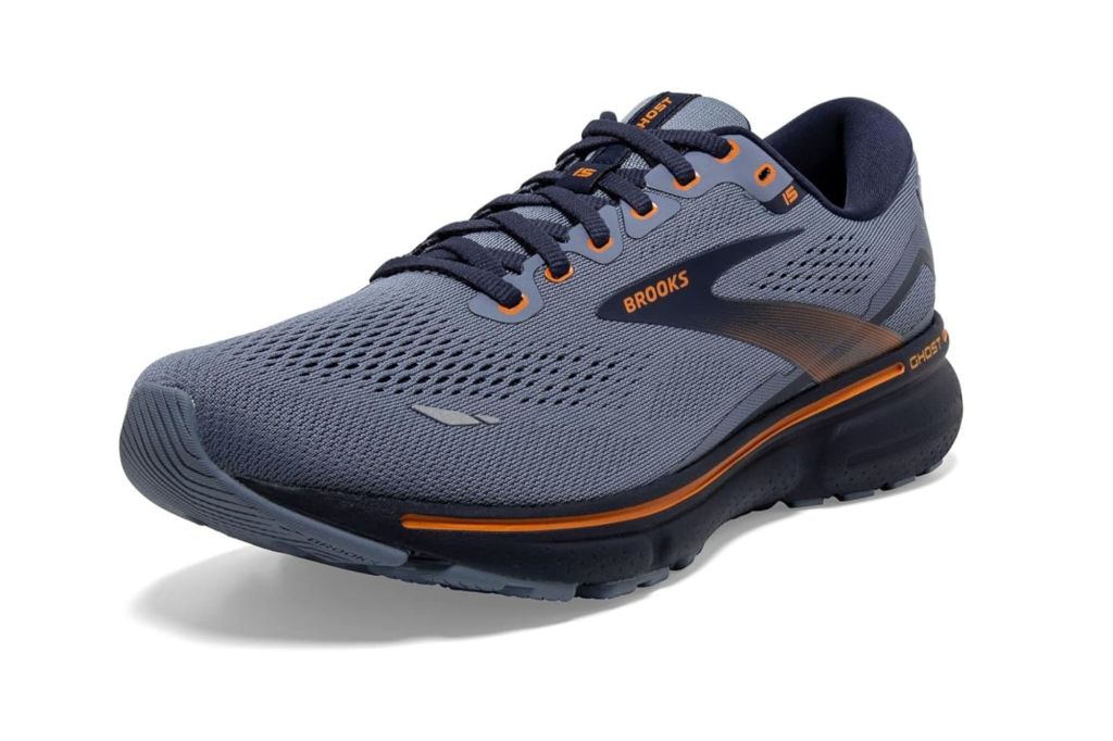 A Brooks running sneaker in the colors grey and orange.
