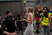 An attendee goes through a security checkpoint to enter Cipriani Wall Street as pro-Palestine protestors hold a rally.