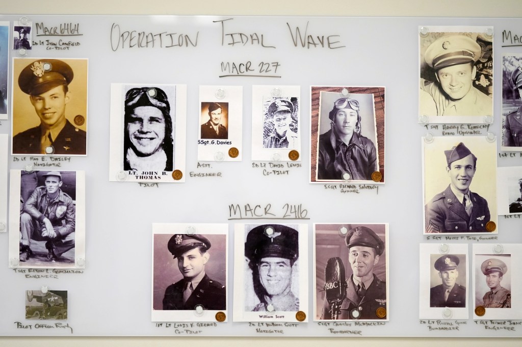 Photos of service members are seen on a wall in a Defense POW/MIA Accounting Agency lab at Offutt Air Force Base, Monday, May 20, 2024, in Bellevue, Neb. 