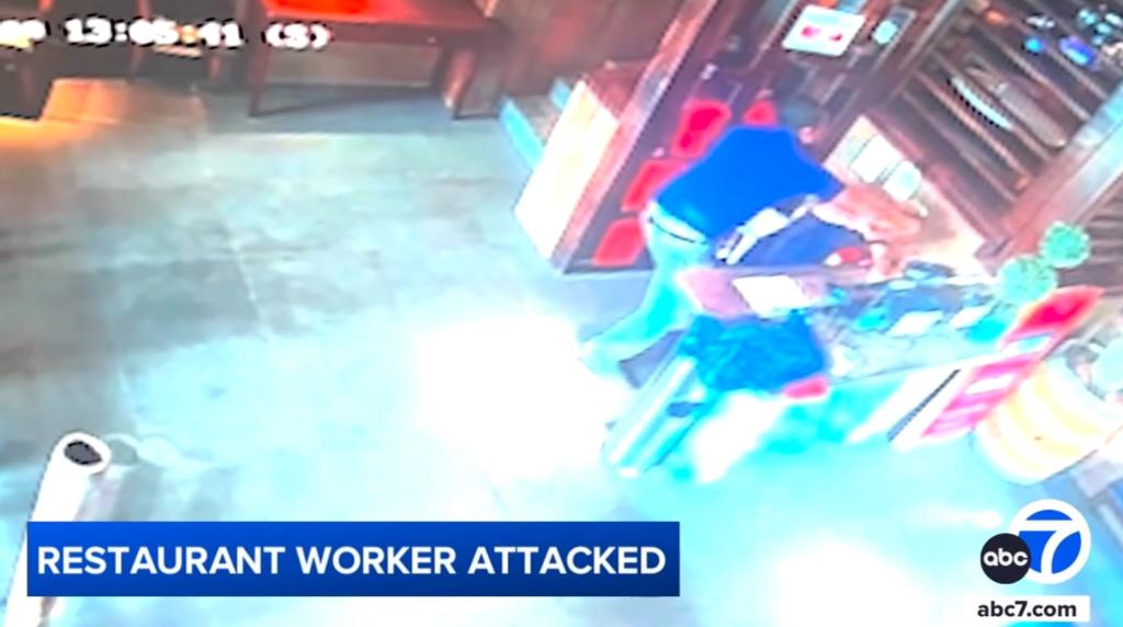 The unidentified man towered over Oxlaj before punching the defenseless worker.