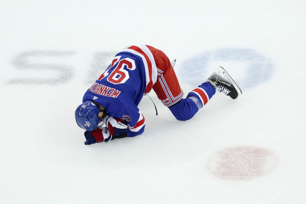 Alex Wennberg #91 of the New York Rangers reacts after a hit during the first period