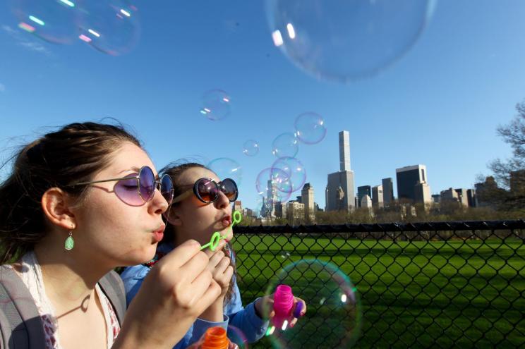 American Musical and Dramatic Academy students Ashley Ryan, 19, left, of the UWS, and Erin Arndt, 20, of Dyckman Heights blow bubbles as they walk through Central Park in New York