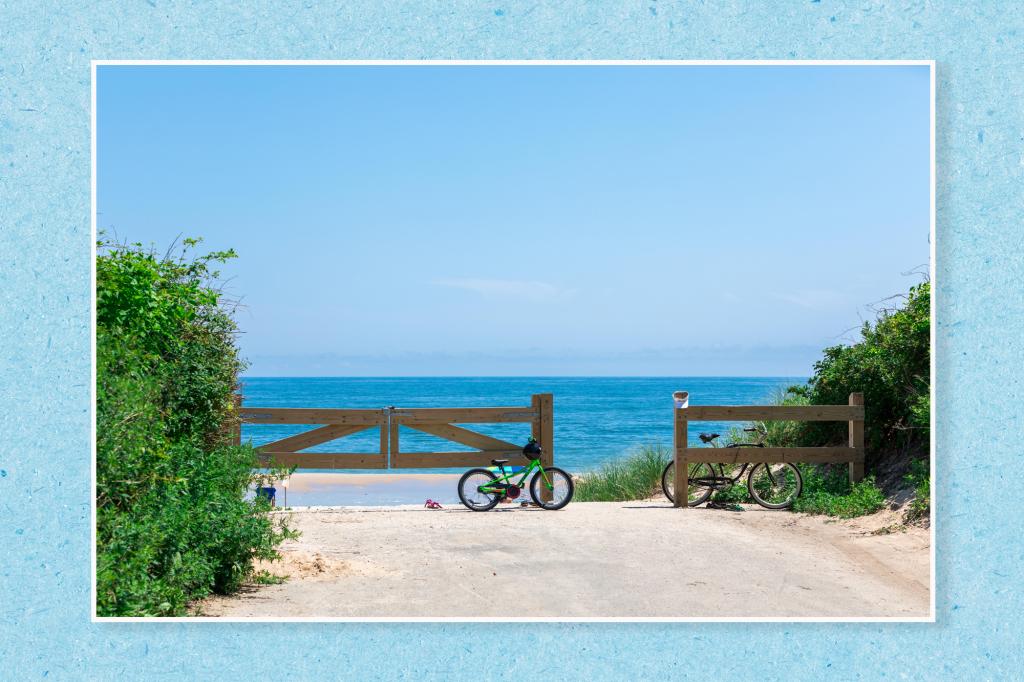 A bicycle parked on a dirt road with a wooden gate and a body of water on a blue paper texture background