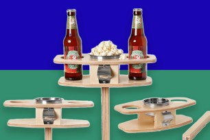 A wooden tray with bottles of beer and popcorn on it