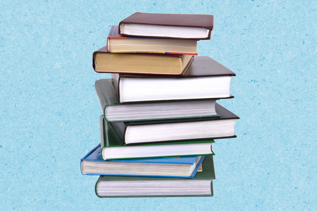 Stack of books on a textured blue paper background