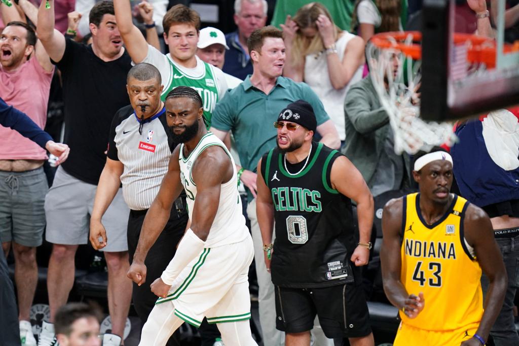 Jaylen Brown flexes after hitting his game-tying shot.