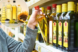 Bottle of olive oil in the hand of the buyer at the grocery store