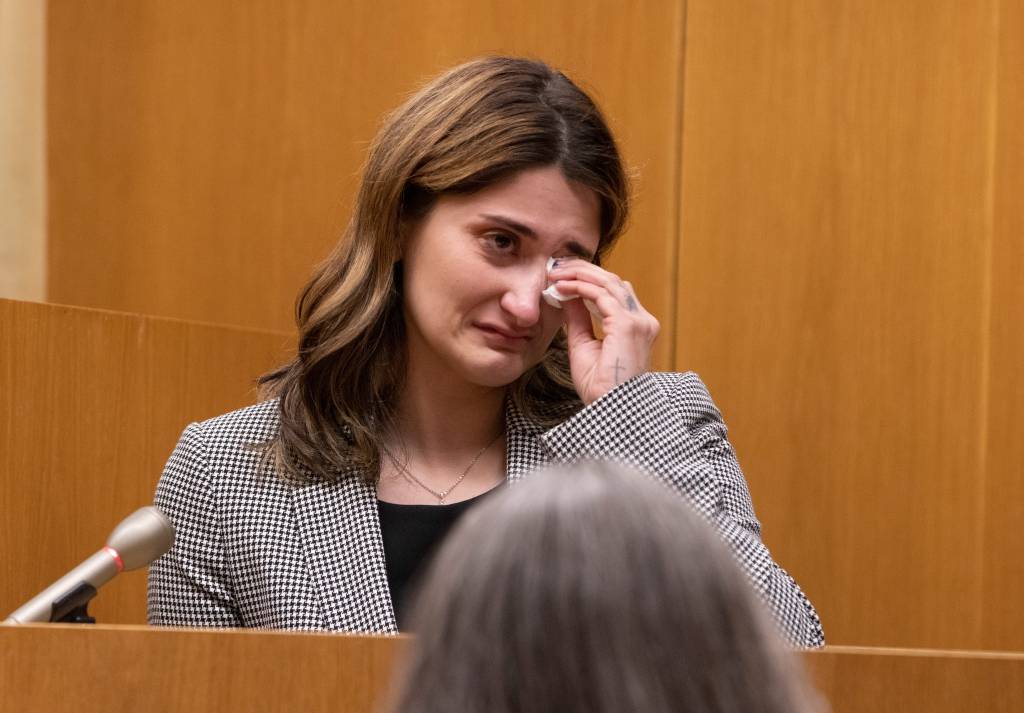 An emotional Bre Micciolo sits at the witness stand as the the fitness center surveillance footage is played in court on April 30, 2024.  