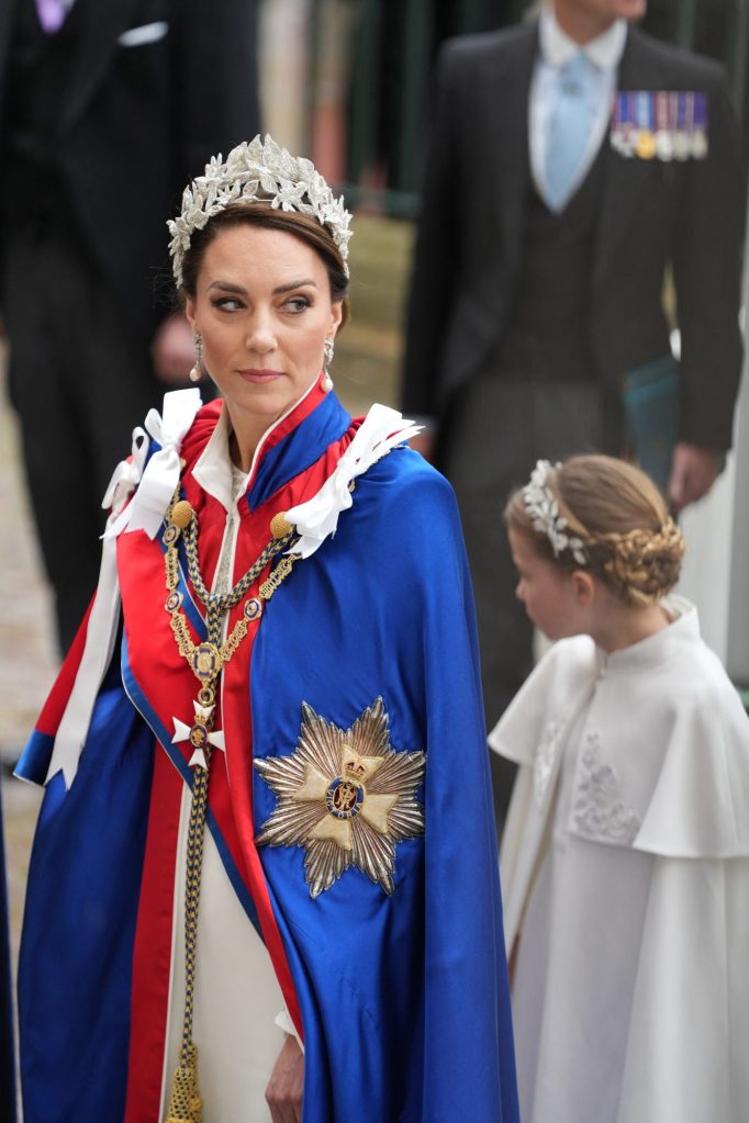 Princess Catherine of Wales in a blue and red robe with a crown, arriving at Westminster Abbey for the coronation of King Charles and Queen Camilla