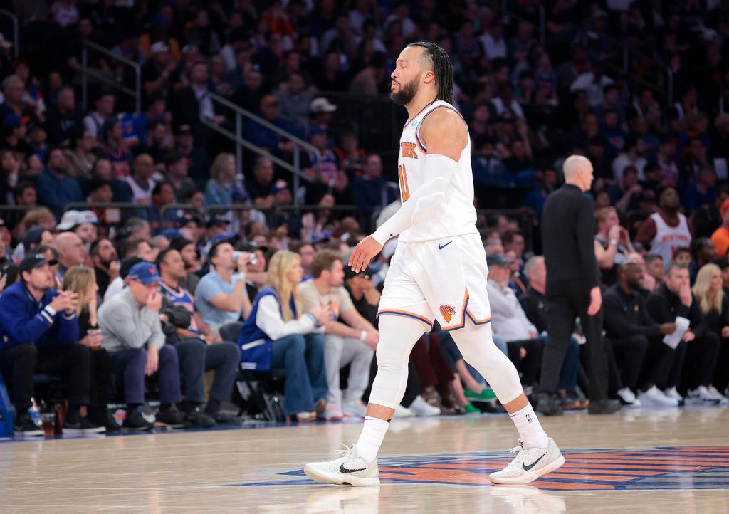 New York Knicks guard Jalen Brunson #11 reacts as he walks to the bench during the third quarter.