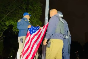 NYPD officers took down a Palestinian flag and re-raised the American flag at City College after breaking up an anti-Israel protest on May 1, 2024.