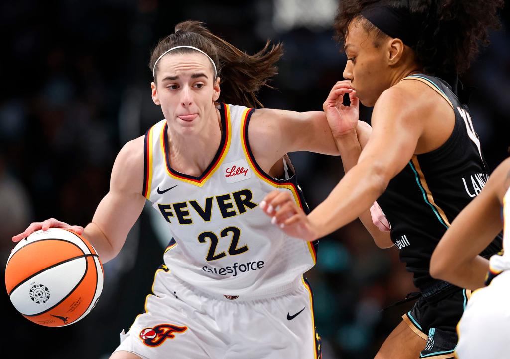 Indiana Fever guard Caitlin Clark (22) drives to the basket against New York Liberty forward Betnijah Laney-Hamilton (44) during the first half of a WNBA basketball game, Saturday, May 18, 2024, in New York.