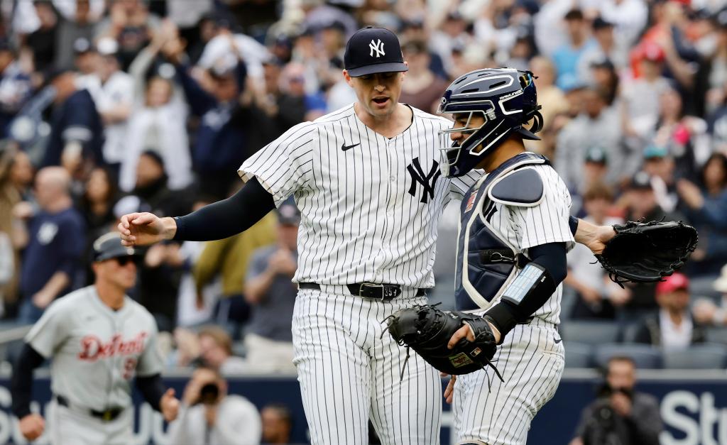 Clay Holmes and catcher Jose Trevino of the New York Yankees celebrating their victory against the Detroit Tigers at Yankee Stadium