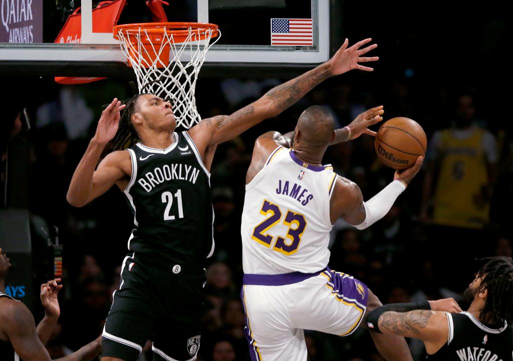 Brooklyn Nets forward Noah Clowney (21) defends against Los Angeles Lakers forward LeBron James (23) during the second half of an NBA basketball game Sunday, March 31, 2024, in New York.