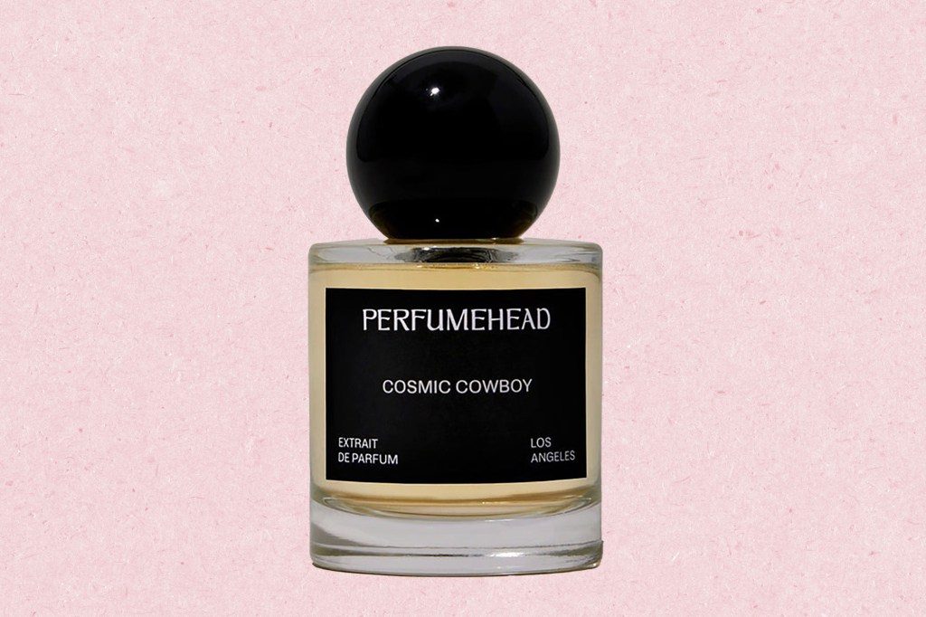 A bottle of perfume with a black cap