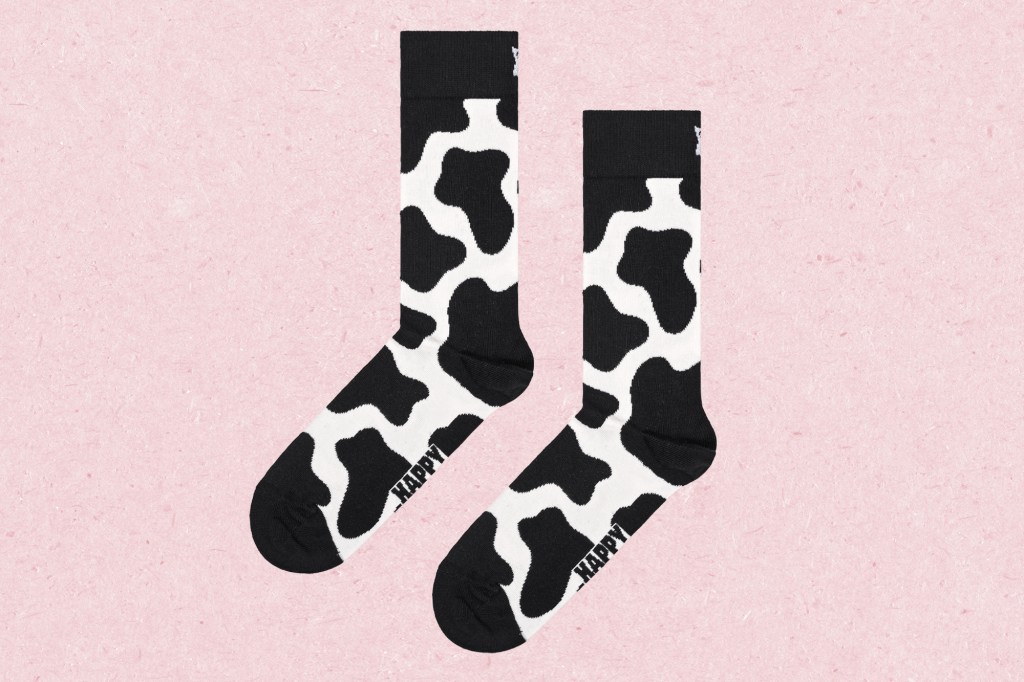 A pair of socks with cow print