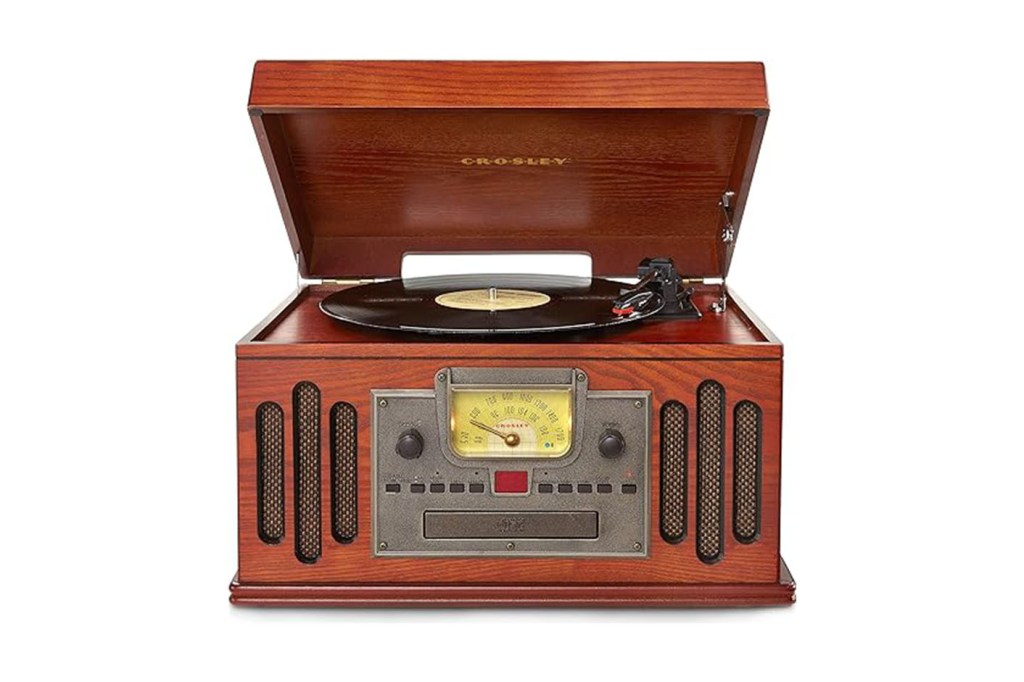 A vintage Crosley record player with a vinyl record on it