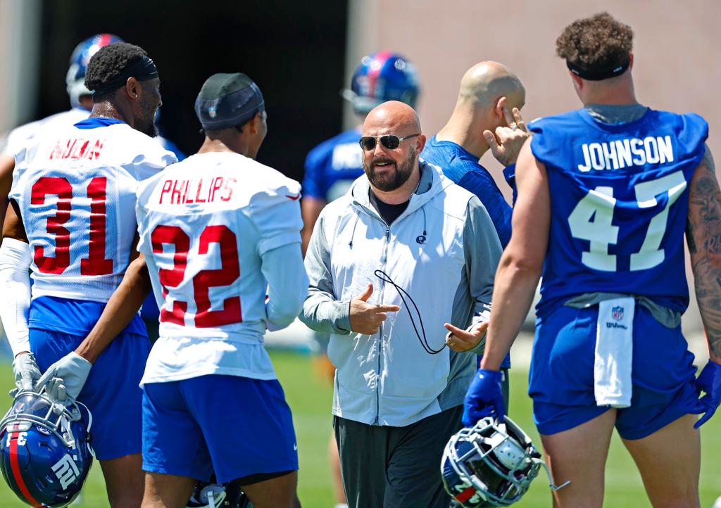 New York Giants head coach Brian Dabol talks to players Tyler Nubin (31) , Dru Phillips (22) and Theo Johnson (47) during Rookie Minicamp, Saturday, May 11, 2024 in East Rutherford, N.J. 