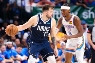 Dallas Mavericks guard Luka Doncic (77) controls the ball as Oklahoma City Thunder guard Shai Gilgeous-Alexander (2) defends