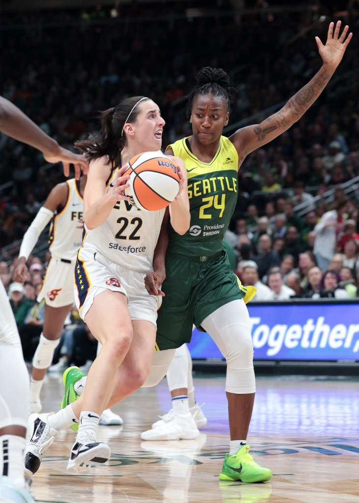 Indiana Fever guard Caitlin Clark (22) is defended by Seattle Storm guard Jewell Loyd (24) during the second half of a WNBA basketball game Wednesday, May 22, 2024, in Seattle. 