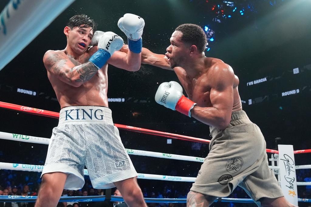 Devin Haney, right, punches Ryan Garcia during the ninth round of a super lightweight boxing match early Sunday, April 21, 2024, in New York. 