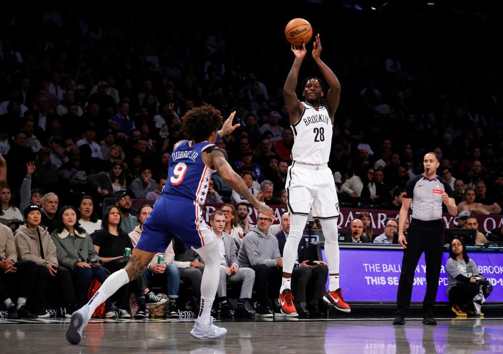 Brooklyn Nets forward Dorian Finney-Smith (R) looks to shoot past a defending Philadelphia 76ers guard Kelly Oubre Jr. (L) during the first half of an NBA basketball game Tuesday, March 5, 2024, in New York. 