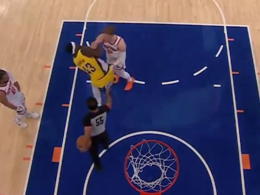 Knicks guard Donte DiVincenzo pushes the Pacers' Pascal Siakam for stalling during a free-throw attempt.