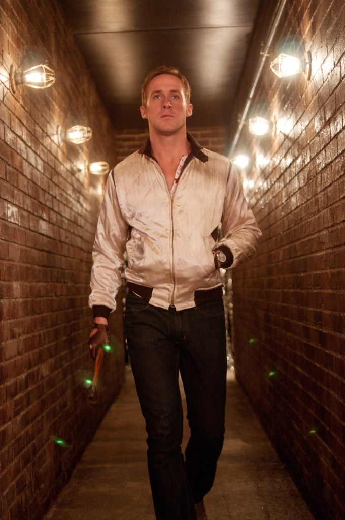 Ryan Gosling walking down a hallway in a scene from the 2011 movie, DRIVE.
