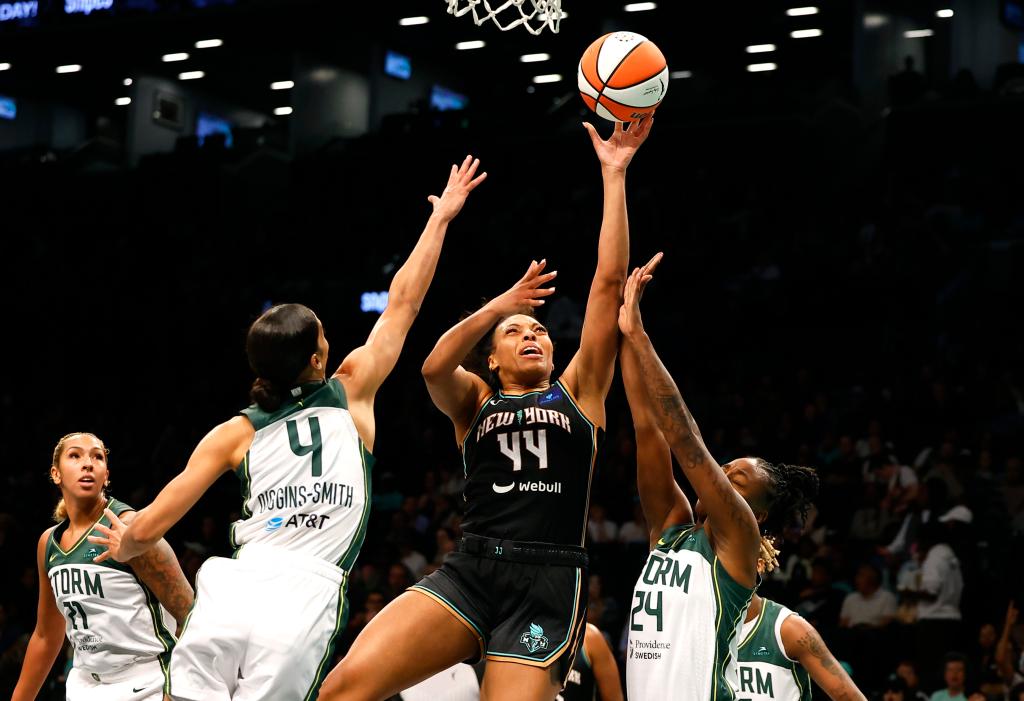 Betnijah Laney-Hamilton (44) drives to the basket against Seattle Storm guards Skylar Diggins-Smith (4) and Jewell Loyd (24) during the first half at the Barclays Center. 