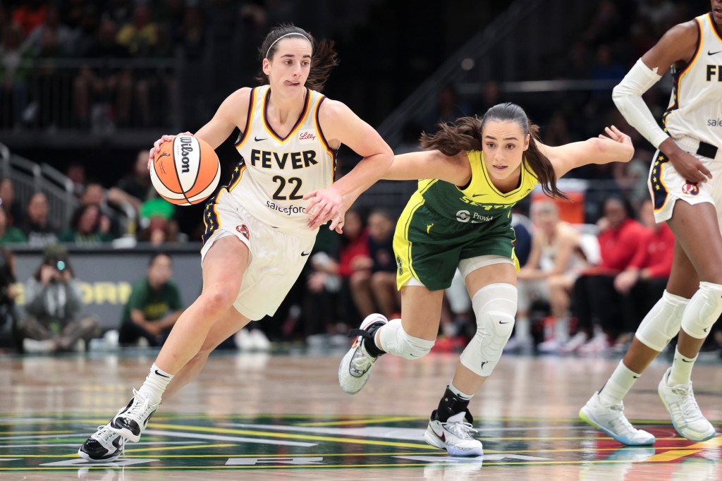 Indiana Fever guard Caitlin Clark (22) drives as Seattle Storm guard Nika Muhl defends during the second half of a WNBA basketball game, Wednesday, May 22, 2024, in Seattle. 