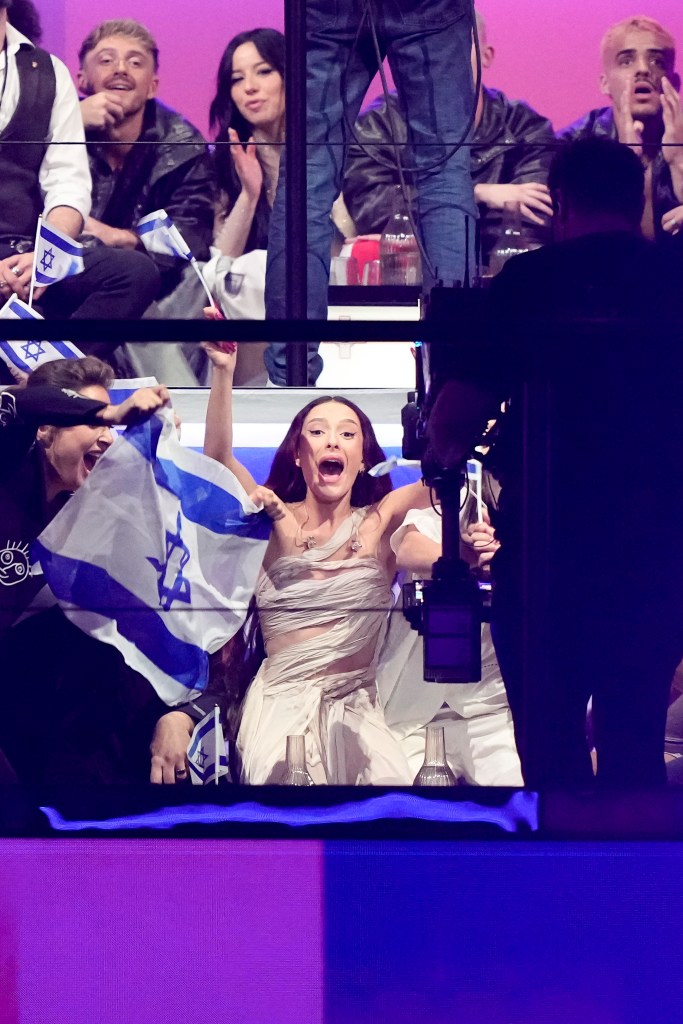 Eden Golan of Israel celebrating her advancement to the Eurovision Song Contest final, holding a flag in Malmo, Sweden, May 9, 2024.