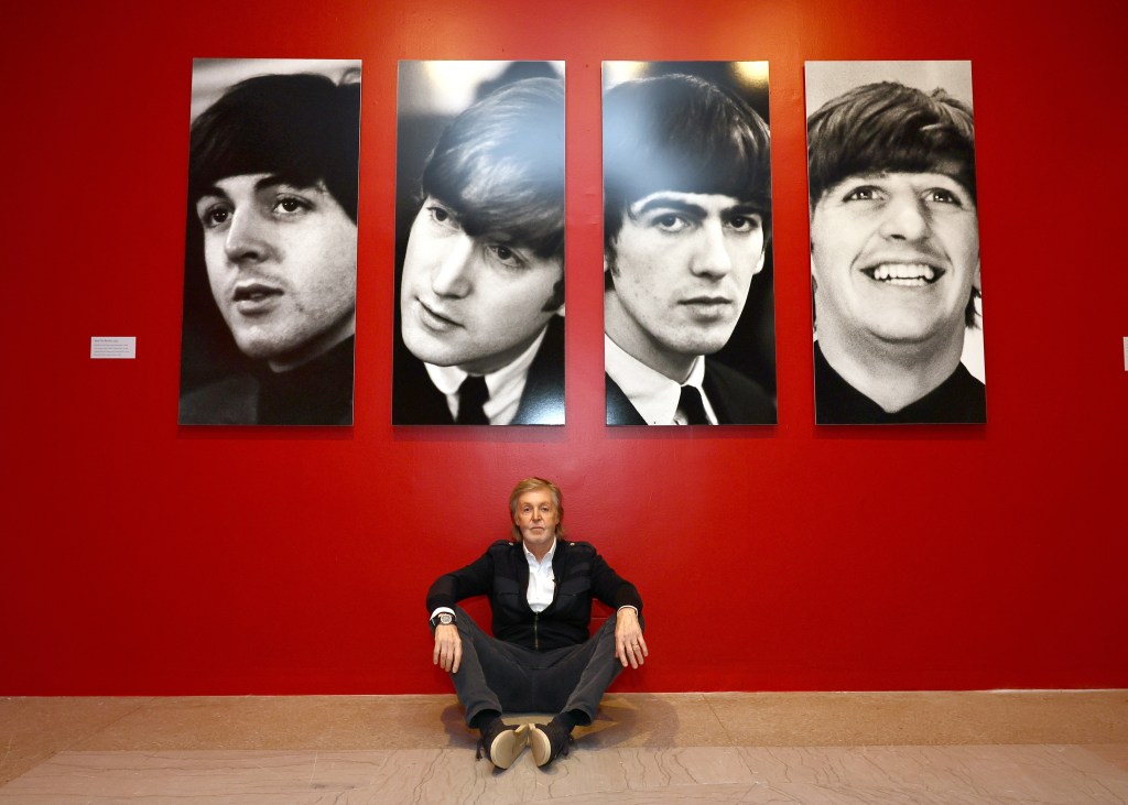 Sir Paul McCartney viewing Paul McCartney Photographs 1963-64: Eyes of the Storm exhibit at Brooklyn Museum, seen sitting in front of blown up pics of the beatles