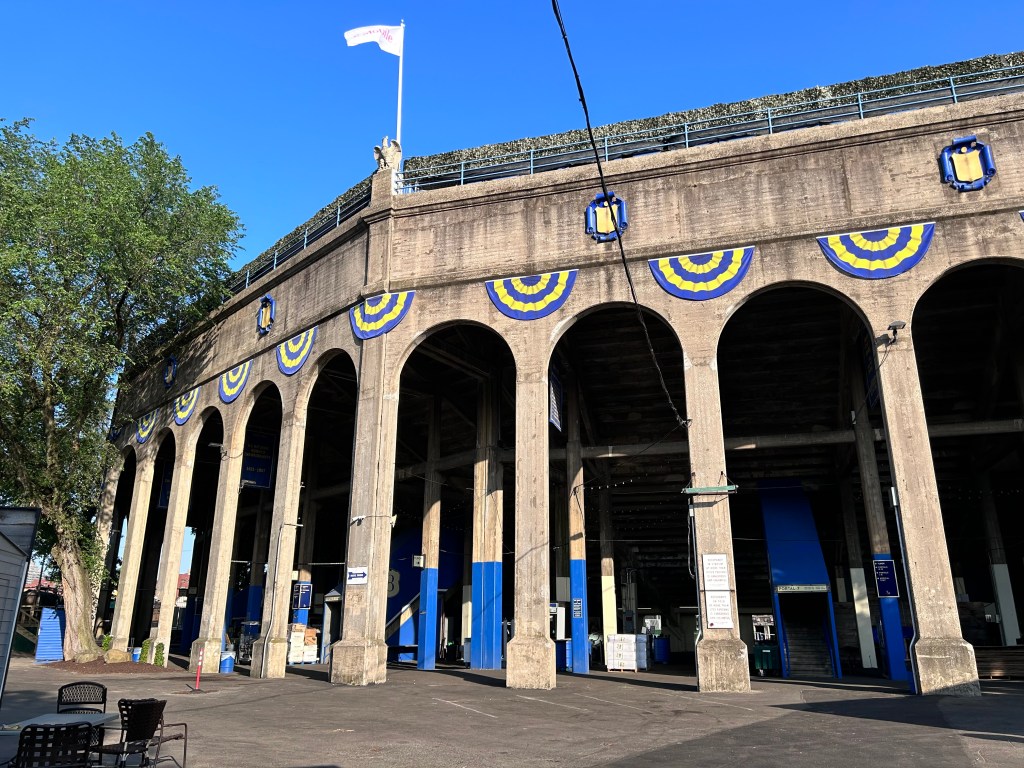 Entrance of the historic Forest Hills Stadium in Queens, New York with a flag fluttering on top