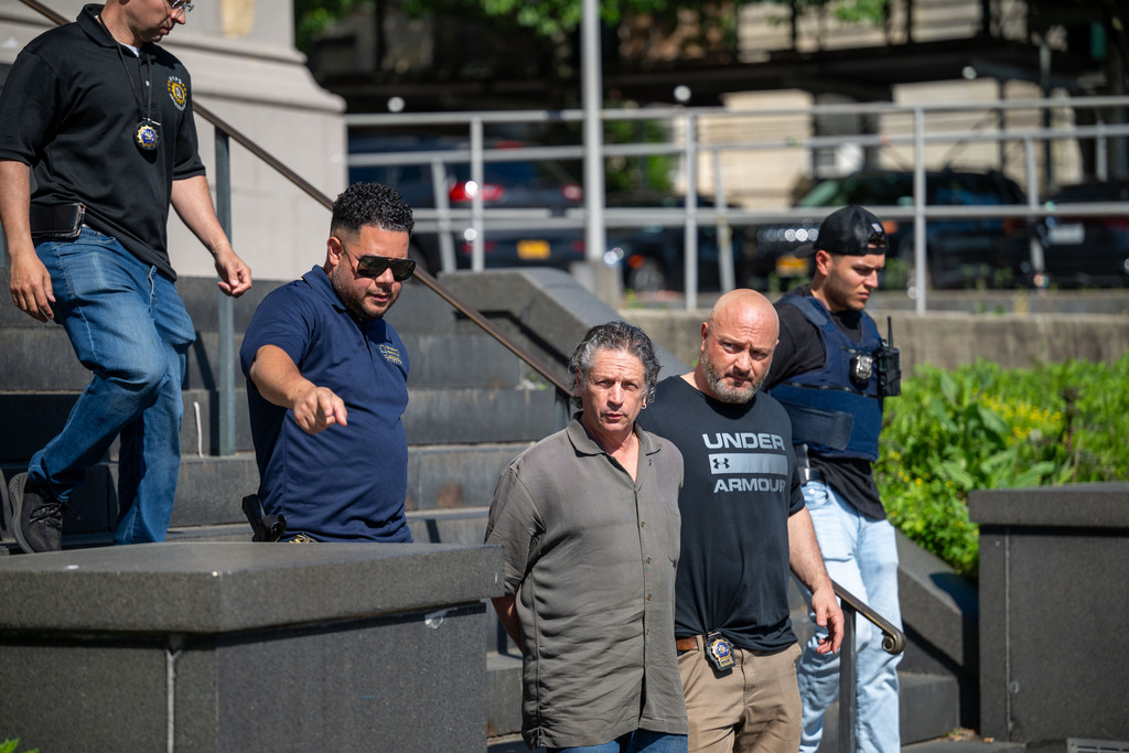 Ettore Mazzei is led out of the 120th police precinct on Wednesday, May 22, 2024, in St. George. 