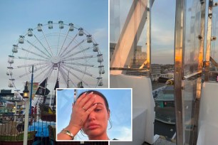 A woman covering her face with her hand in fear near a ferris wheel at night