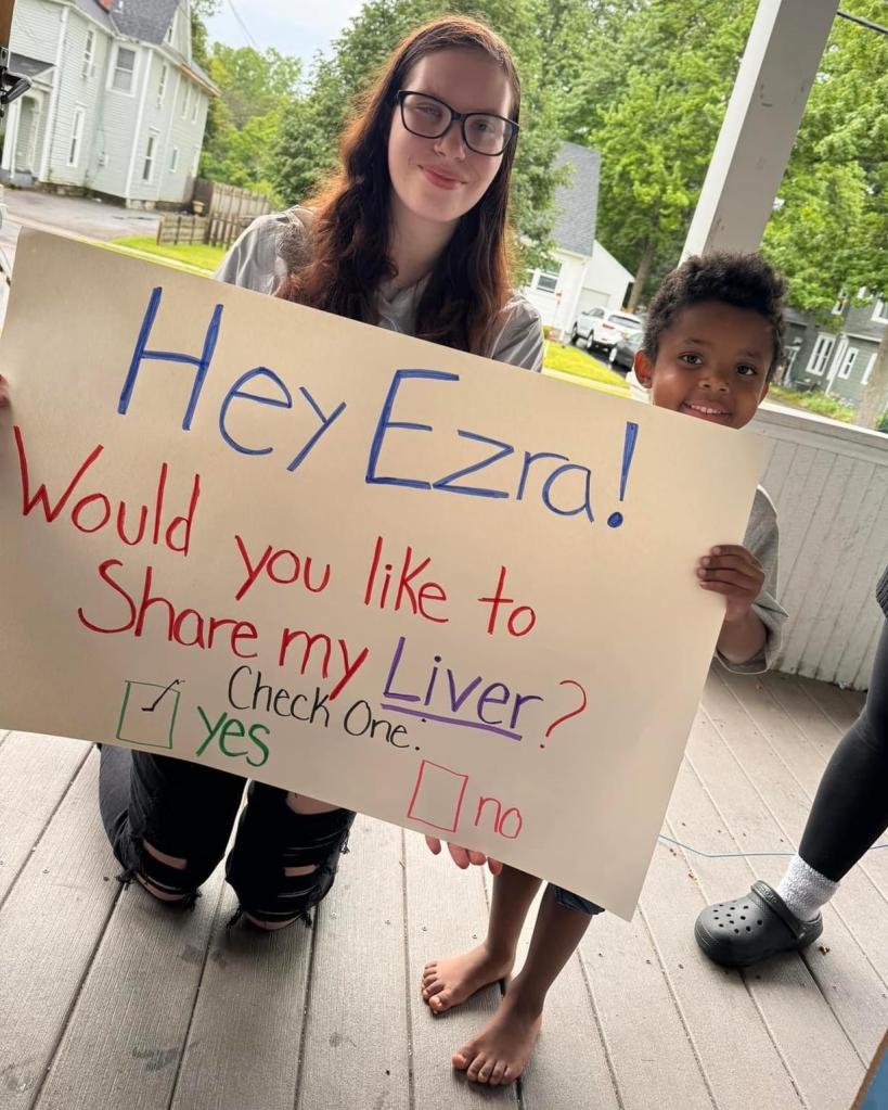Fisher holding sign with Ezra
